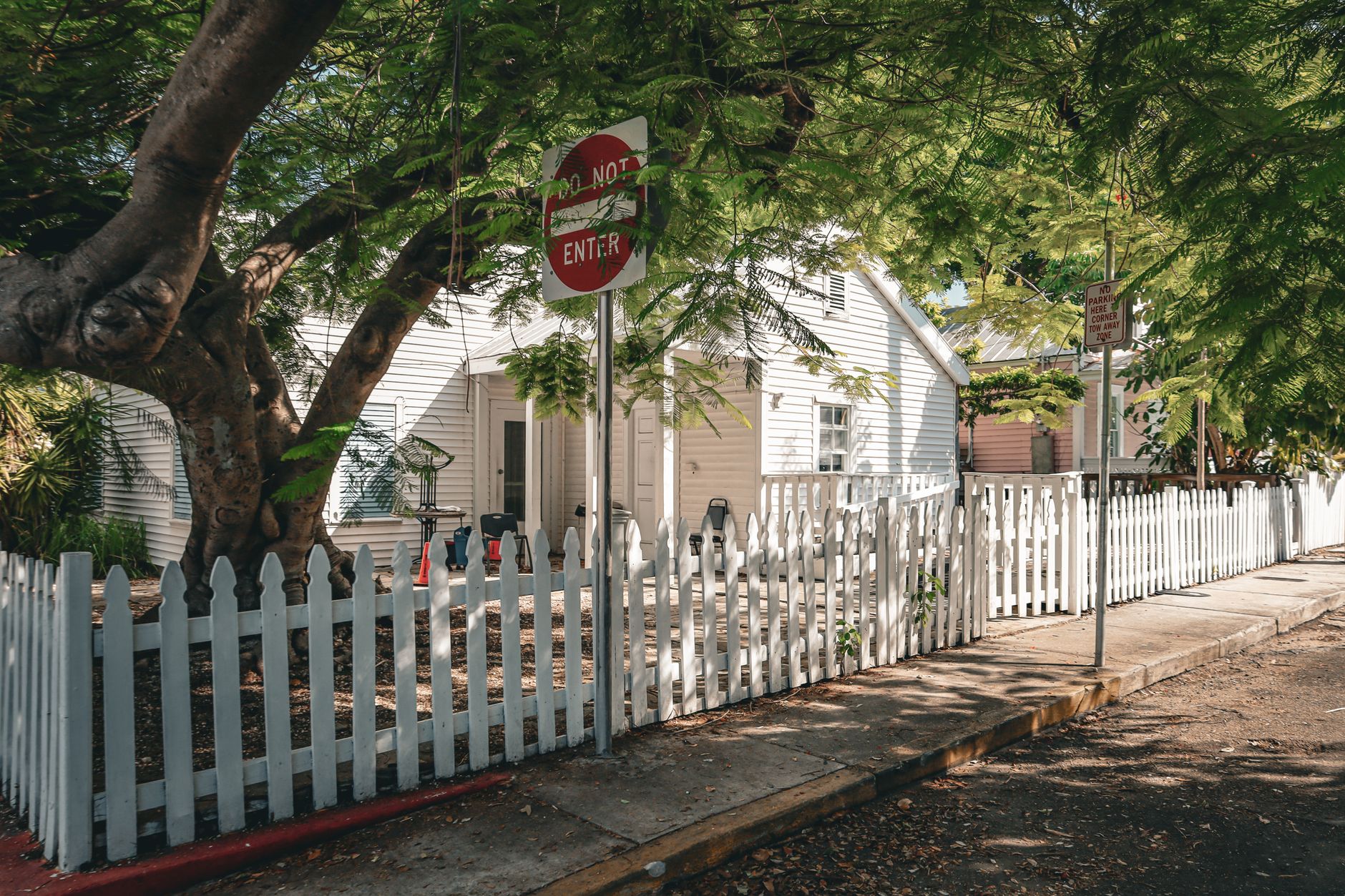 White vinyl picket fence around a residential front yard